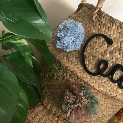 Wicker basket with name and pom pom